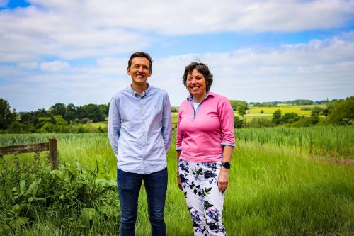 Henry left, Leonie right, with picturesque fields in the background at Brindle & Green Head office.